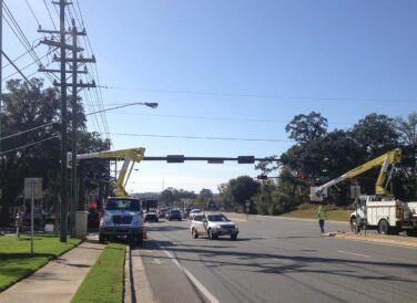 trucks and workers at traffic stop intersection